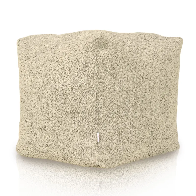 Pouf beige doux en tissu boucle pour des espaces confortables