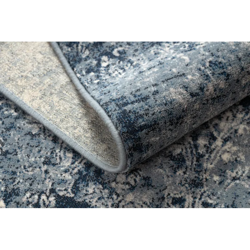 Tapis vintage bleu foncé et beige, idéal pour la décoration du salon