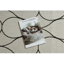 Tapis élégant en crème et noir, idéal pour le salon